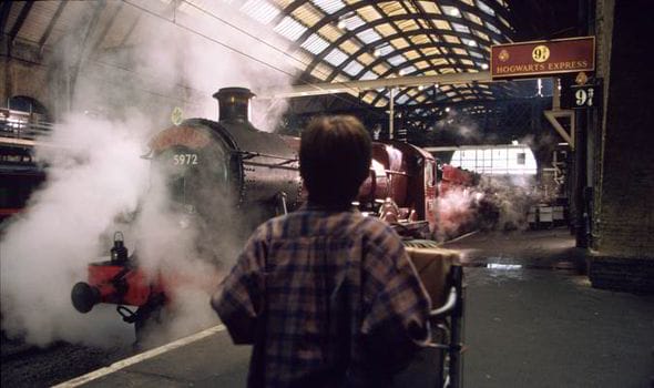 Harry Potter pushing his trolley towards the Hogwarts Express