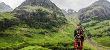 Scottish bagpiper at Glencoe, Scotland