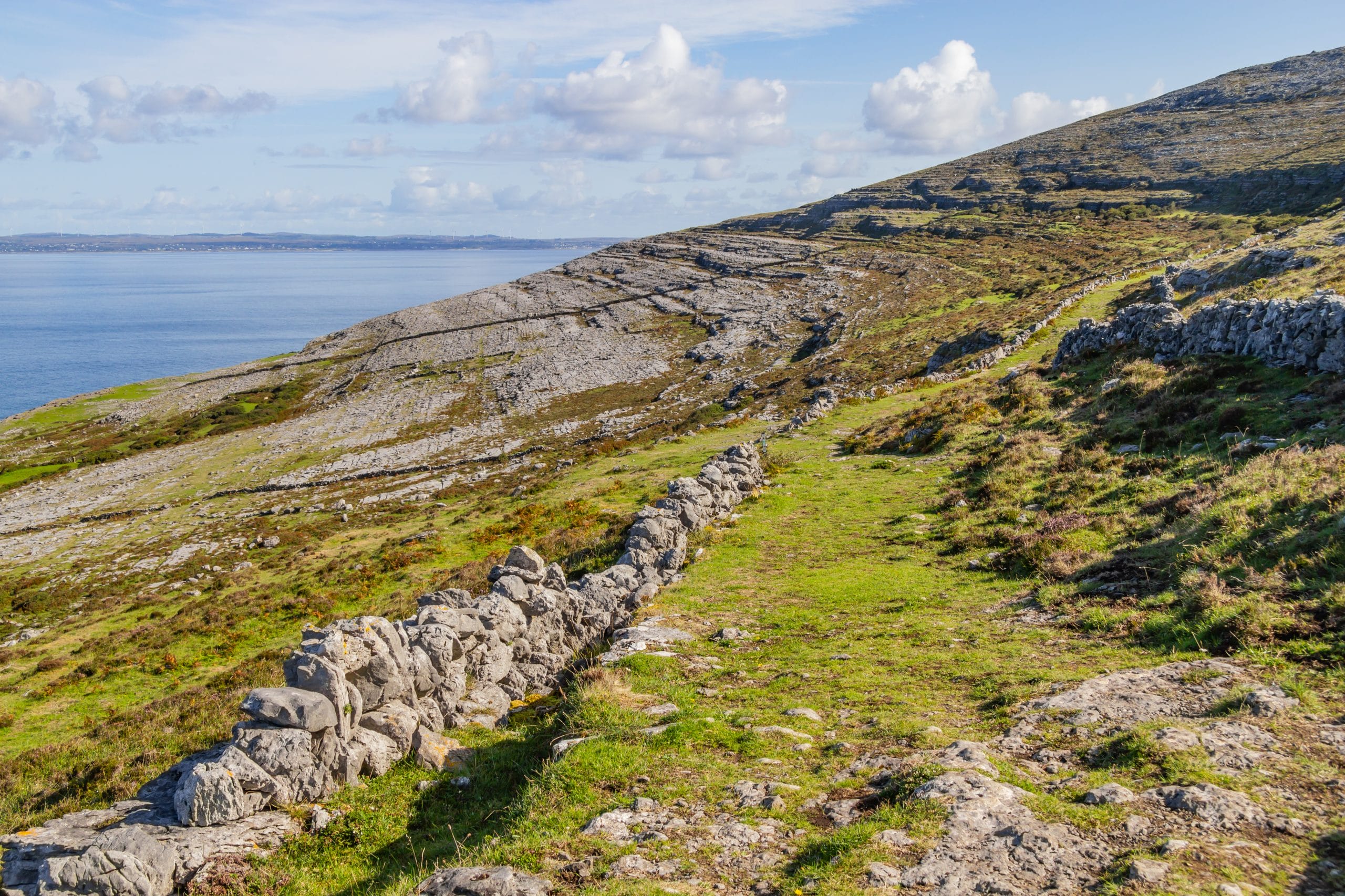 hiking trail with stone walls in burren mountains