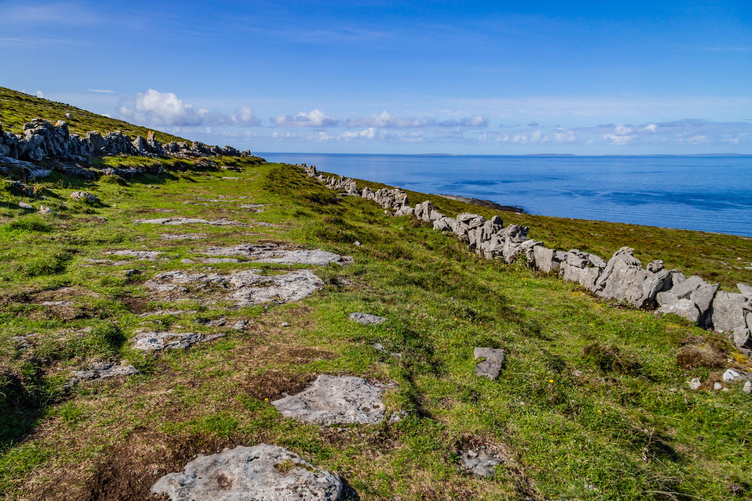 burren way trail with aran islands in background