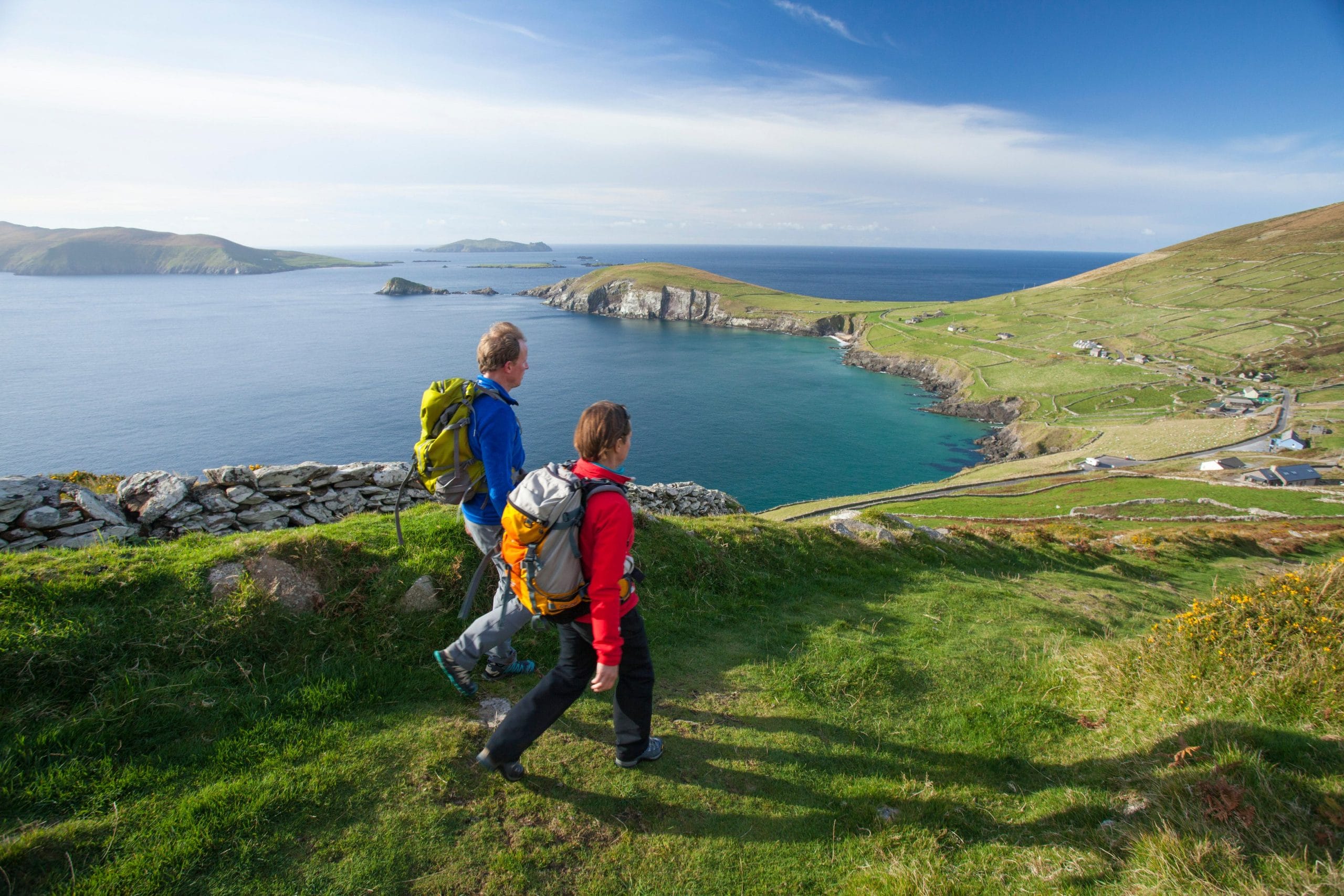 walkers on the dingle way above slea head, dingle peninsula, county kerry, ireland.