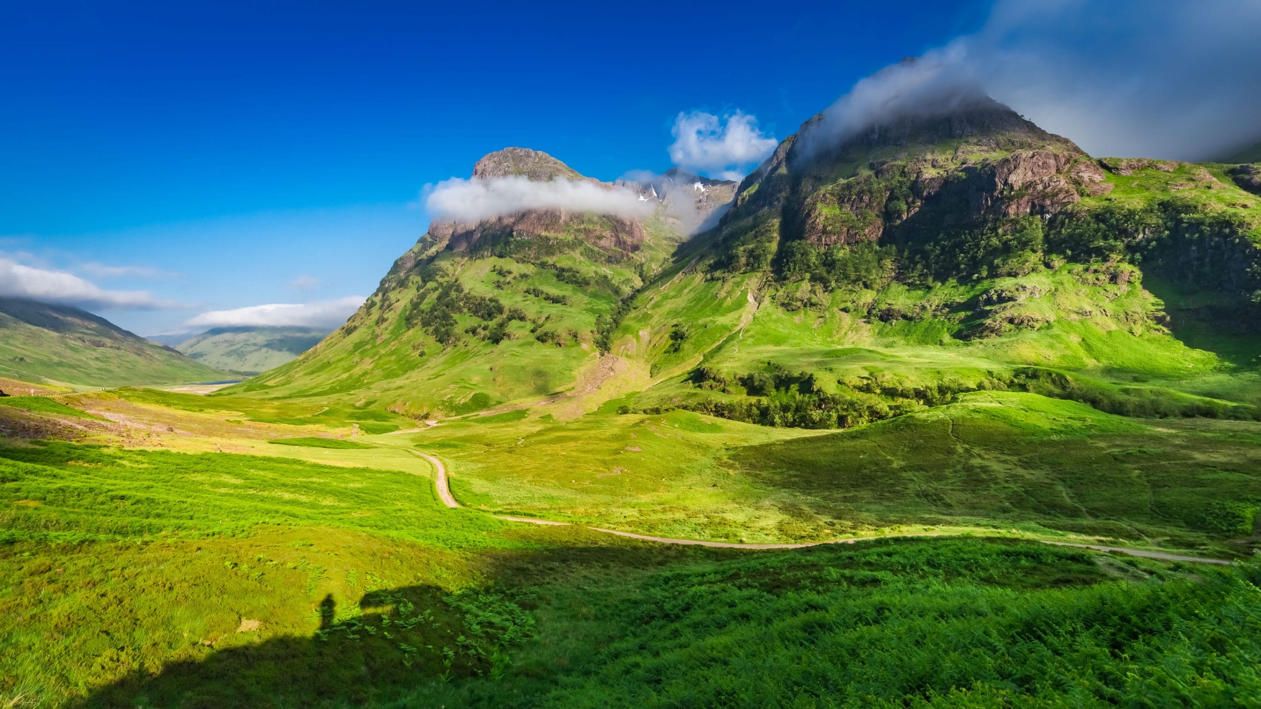beautiful sunrise and tiny shadow of man, glencoe, scotland
