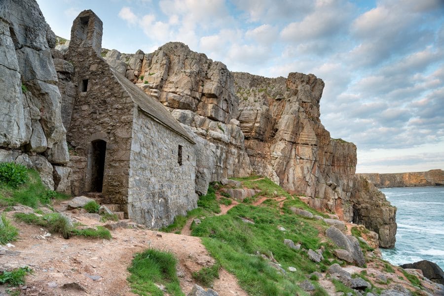 St Govan's Chapel, a tiny medieval hermit cell built in to the cliffs on a rugged stretch of coastline at Pembrokeshire in Wales
