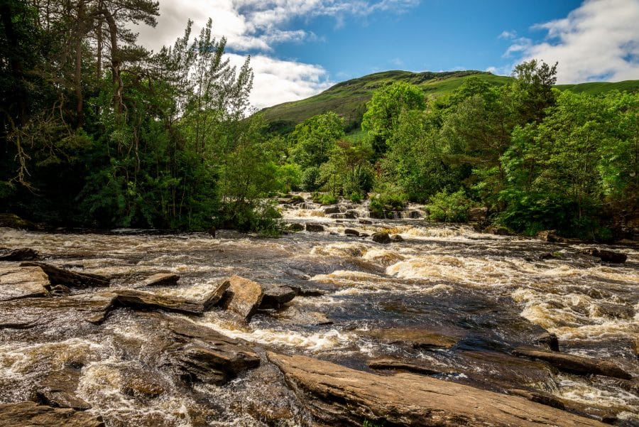 Falls of Dochart river and mountain background landscape at town of Killin, central Scotland