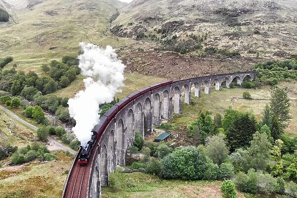 West Highland Line: Train & Hike Holidays crossing the Glenfinnan Viaduct in Scotland.