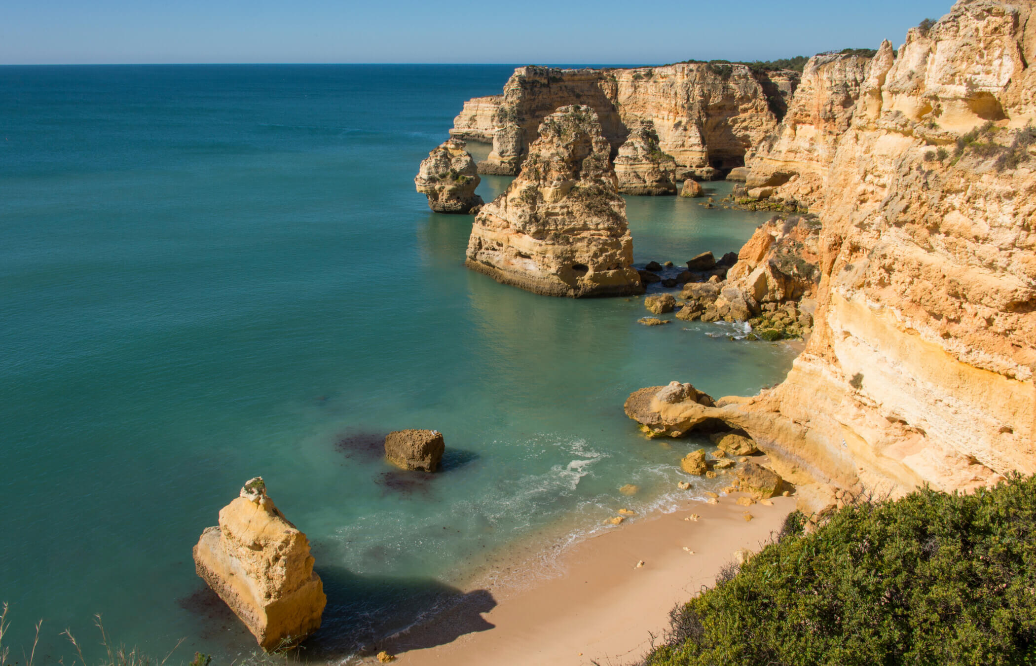 Golden Cliffs plunge into the serene blue ocean at Praia da Marinha in the Algarve's Golden South West