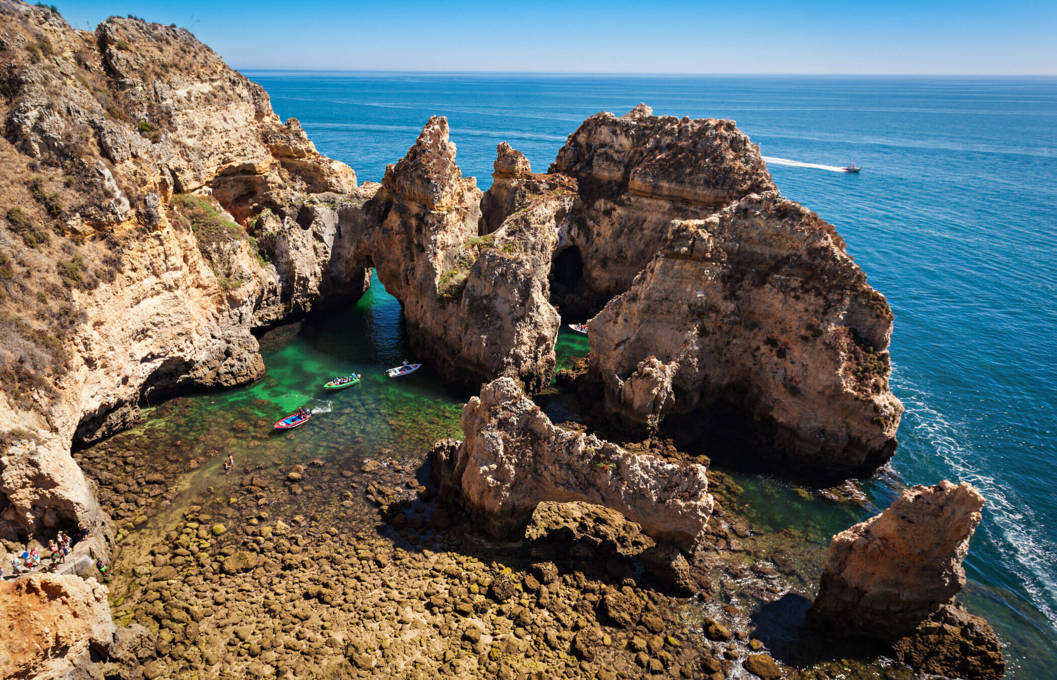 Arches, caves, and towering sea stacks rise dramatically from the turquoise waters at Ponta da Piedade in Portugals Algarve Region.